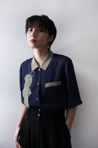 NAVY BLOUSE WITH ABSTRACT LEAF
